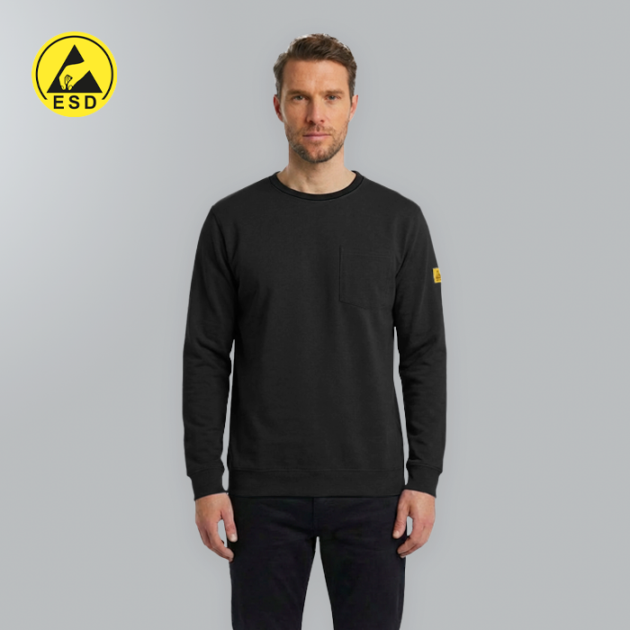 Man wearing a black sweatshirt with a yellow logo on a gray background