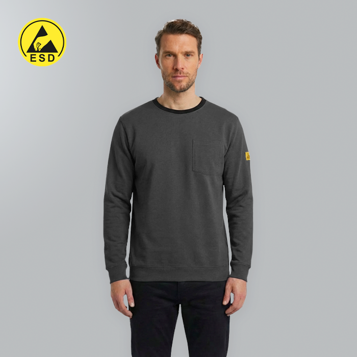 Man wearing a dark gray sweatshirt with a yellow logo on a gray background