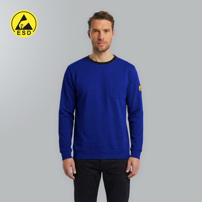 Man wearing a blue sweater with a yellow logo on a gray background