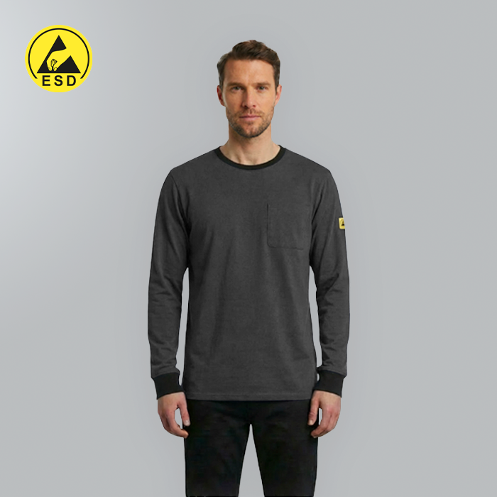 Man wearing a gray long-sleeve shirt with a yellow logo on a gray background