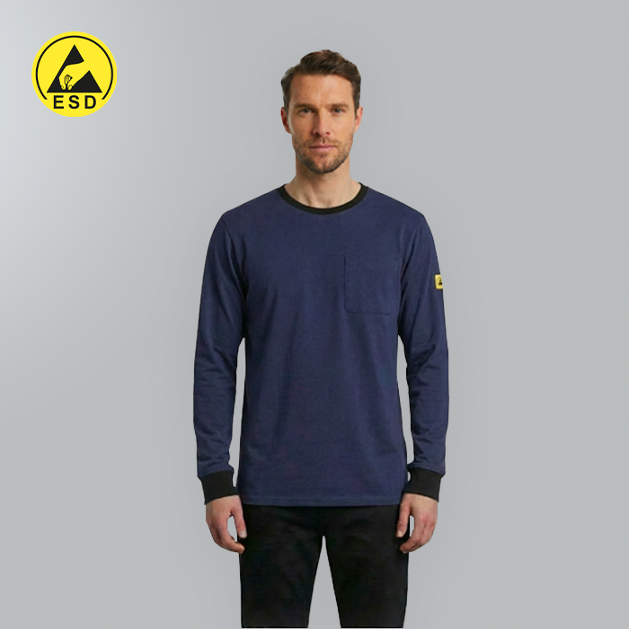 Man wearing a navy long-sleeve shirt with a yellow ESD logo on a gray background
