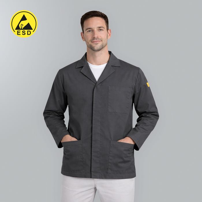 Man wearing a gray work coat with ESD logo on a gray background