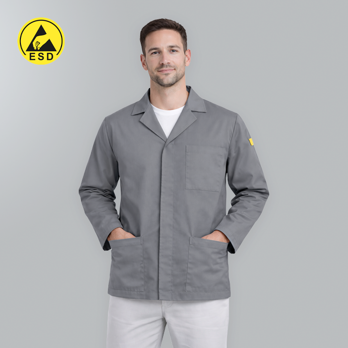 Man wearing a gray lab coat with ESD logo on a gray background
